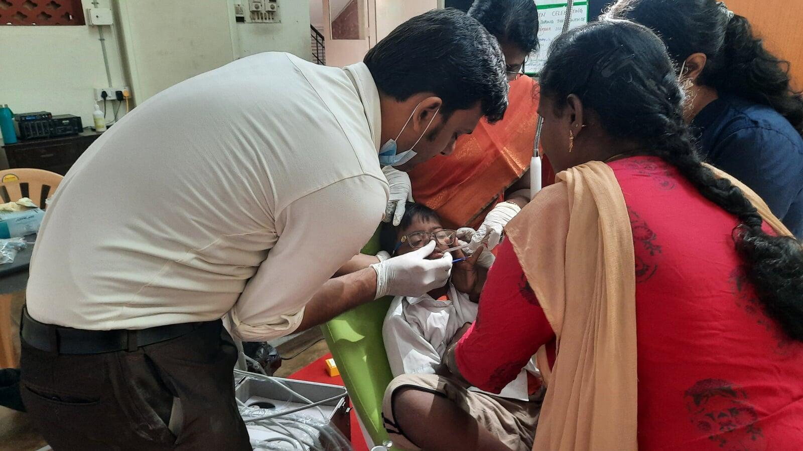 Performing Dental Fluoride Application at institute